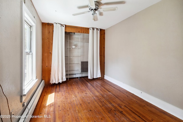 675 Apple Tree Rd, Harding, PA 18643 - unfurnished bedroom featuring a baseboard radiator, multiple windows, hardwood / wood-style floors, and baseboard heating