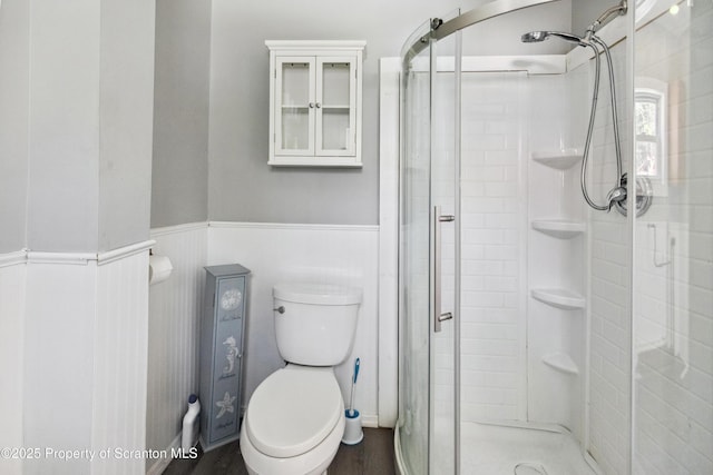 675 Apple Tree Rd, Harding, PA 18643 - bathroom with a stall shower, a wainscoted wall, and wood finished floors