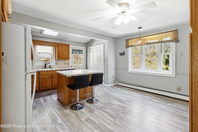 675 Apple Tree Rd, Harding, PA 18643 - kitchen featuring freestanding refrigerator, baseboard heating, light countertops, a center island, and healthy amount of natural light