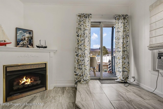 interior space with a warm lit fireplace and baseboards