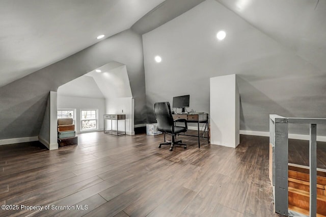 home office featuring high vaulted ceiling, baseboards, and wood finished floors