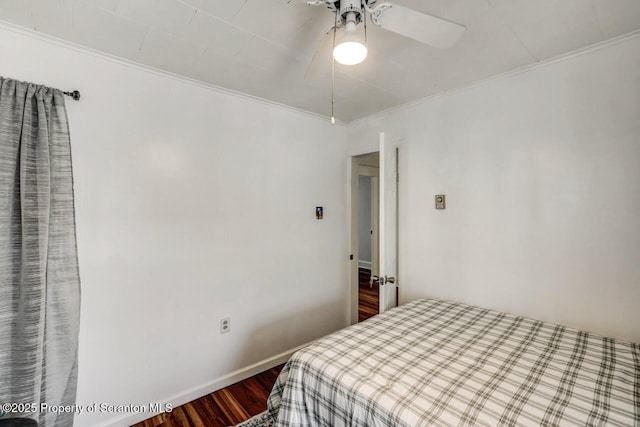 bedroom with ceiling fan, ornamental molding, dark wood-style flooring, and baseboards