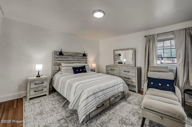 bedroom featuring wood finished floors and baseboards