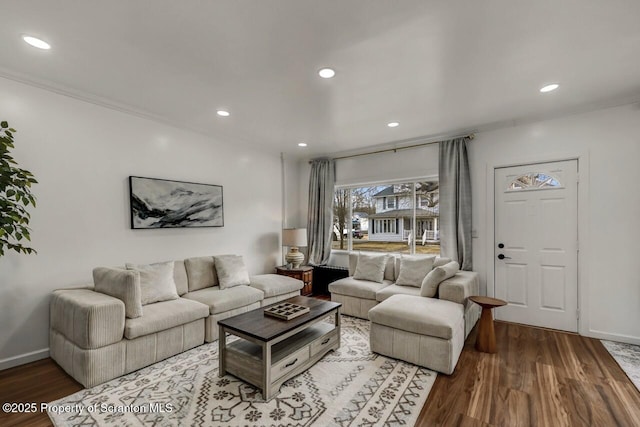 living area featuring recessed lighting, baseboards, and wood finished floors