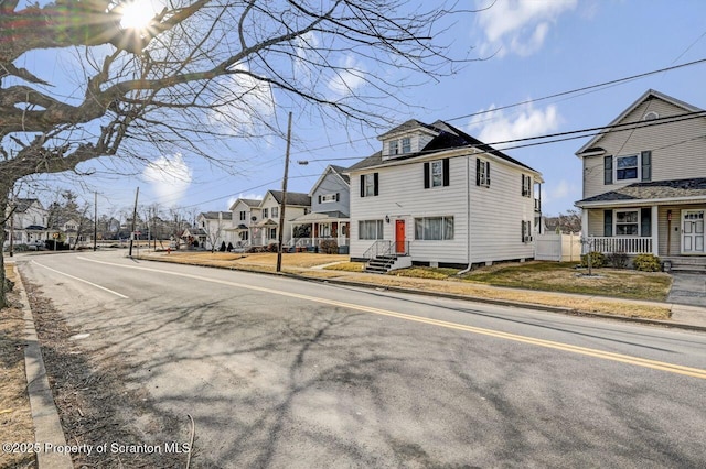 view of road featuring sidewalks, a residential view, and curbs