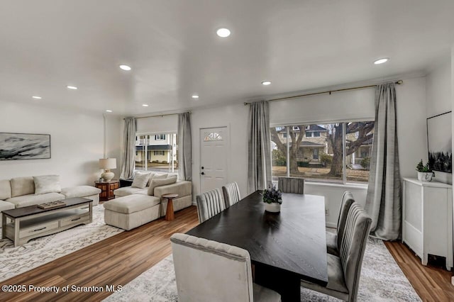 dining space with recessed lighting, plenty of natural light, and wood finished floors