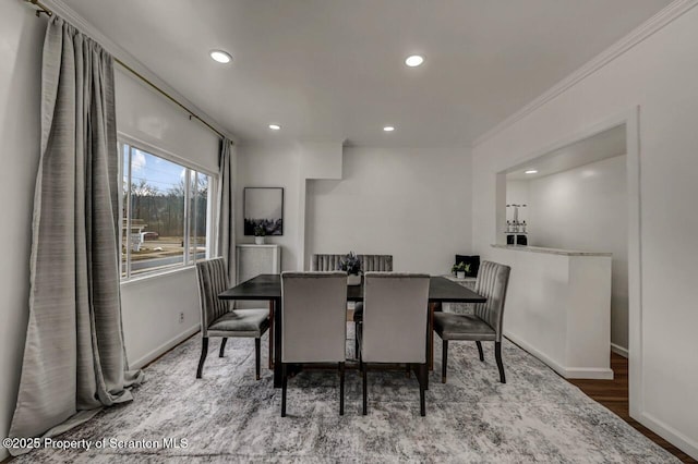 dining room with recessed lighting, crown molding, baseboards, and wood finished floors