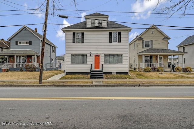 american foursquare style home featuring a porch