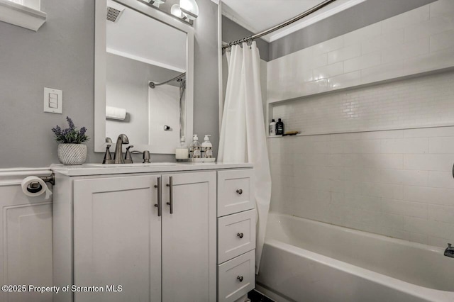 bathroom with vanity, visible vents, and shower / tub combo with curtain