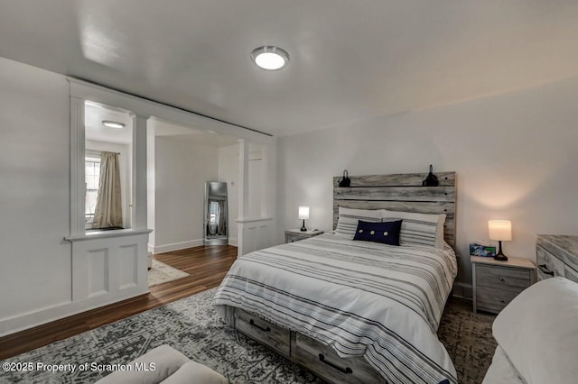 bedroom with baseboards and wood finished floors