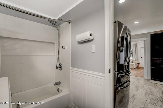 full bathroom with wainscoting, recessed lighting, marble finish floor, and shower / bathtub combination