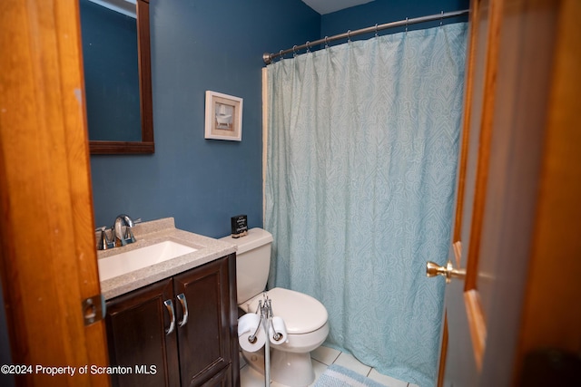 bathroom featuring tile patterned flooring, vanity, and toilet