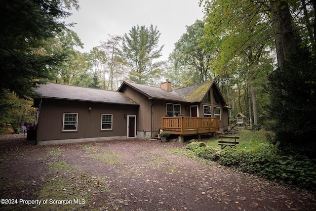 rear view of house with a wooden deck