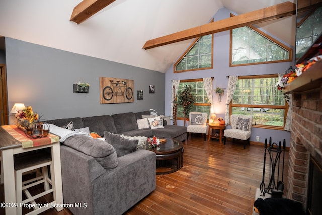 living room with dark hardwood / wood-style floors, beam ceiling, high vaulted ceiling, and a brick fireplace