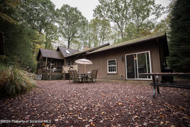 back of property featuring a deck