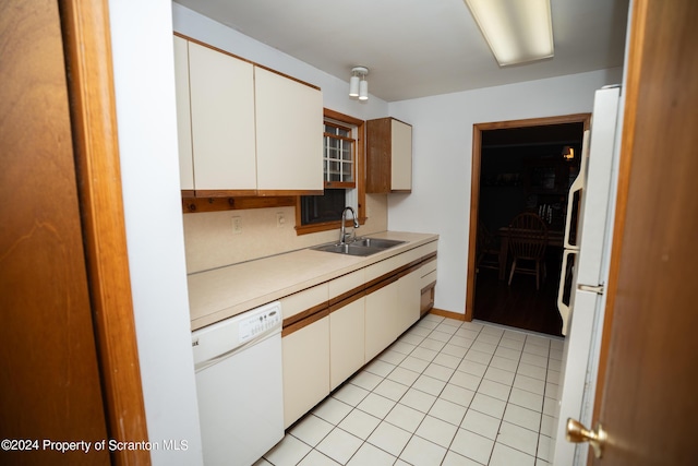 kitchen with backsplash, sink, dishwasher, white cabinets, and light tile patterned flooring