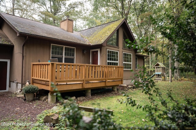 rear view of property featuring a wooden deck