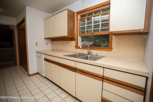 kitchen with dishwasher, white cabinets, sink, decorative backsplash, and light tile patterned flooring