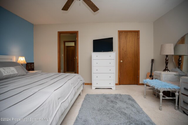 carpeted bedroom featuring ceiling fan