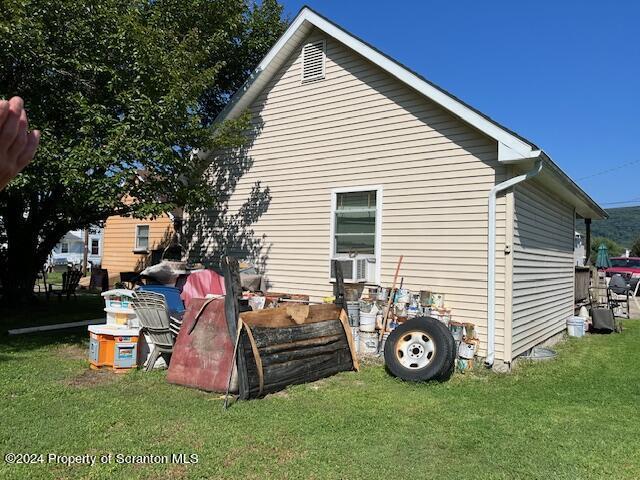 view of side of property with a lawn