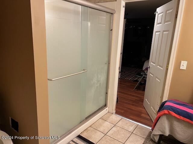 bathroom featuring tile patterned flooring and walk in shower