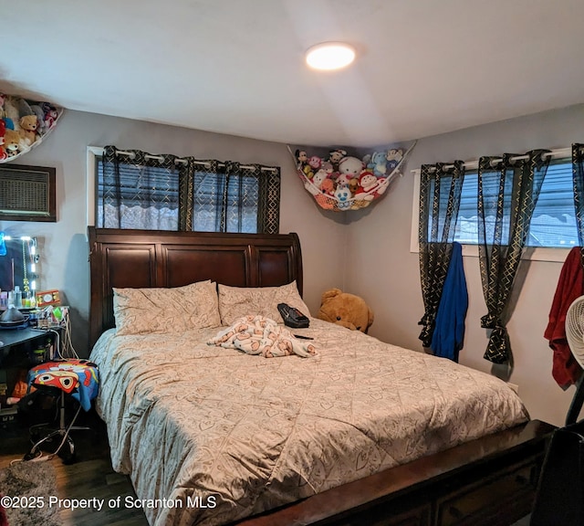 bedroom with hardwood / wood-style floors