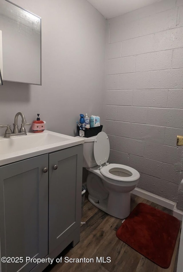 bathroom featuring hardwood / wood-style flooring, vanity, and toilet