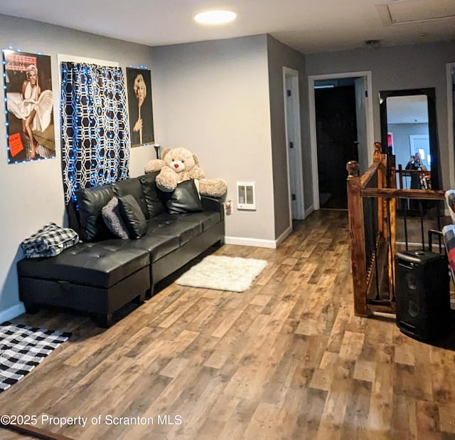 living room with hardwood / wood-style floors and heating unit