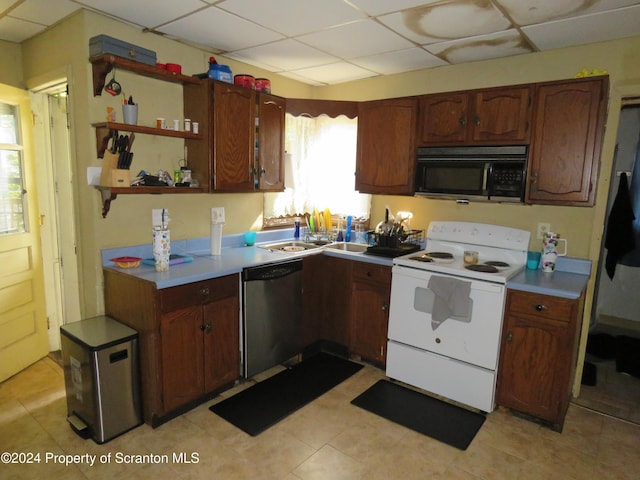 kitchen with white range with electric stovetop, a drop ceiling, and stainless steel dishwasher