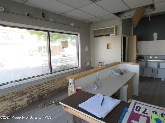 kitchen featuring a paneled ceiling and a wall mounted AC