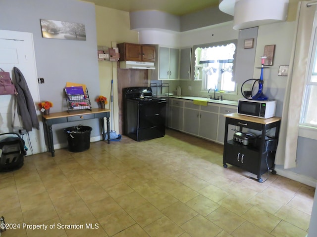 kitchen with black range with electric cooktop, gray cabinetry, and sink