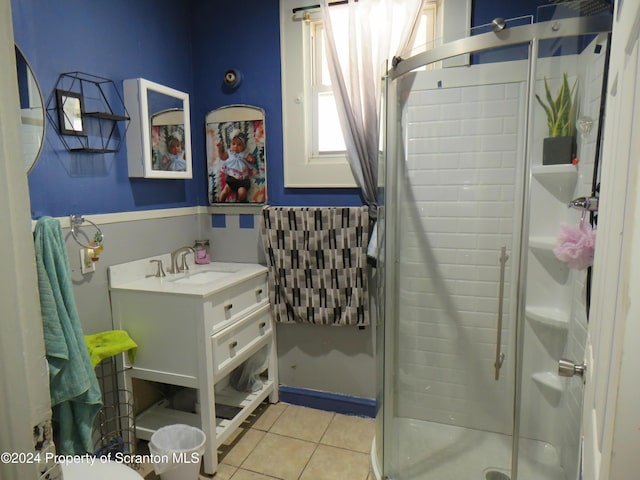 bathroom with tile patterned floors, vanity, and a shower with shower door