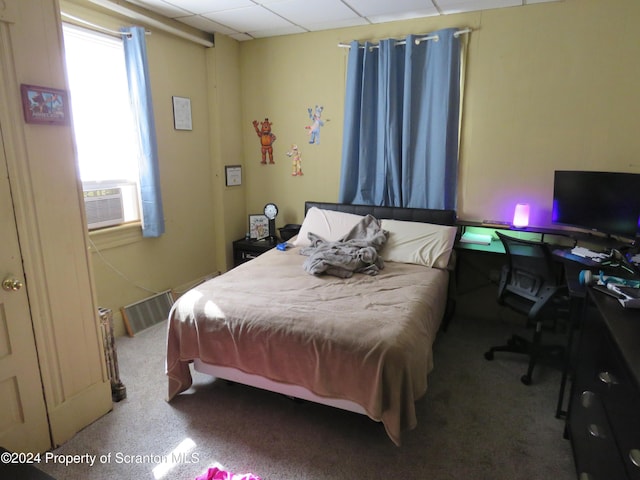 bedroom with cooling unit and carpet floors