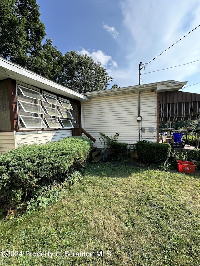 view of home's exterior with a yard