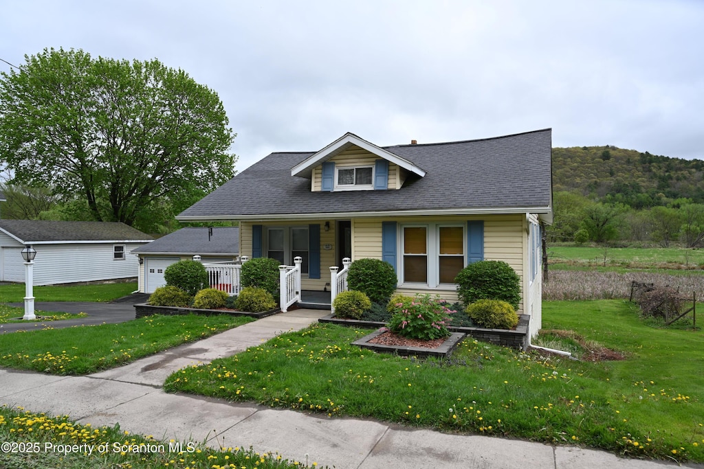 492 Main St, Hallstead, PA 18822 - bungalow-style home with covered porch, aphalt driveway, a garage, a front lawn, and a shingled roof