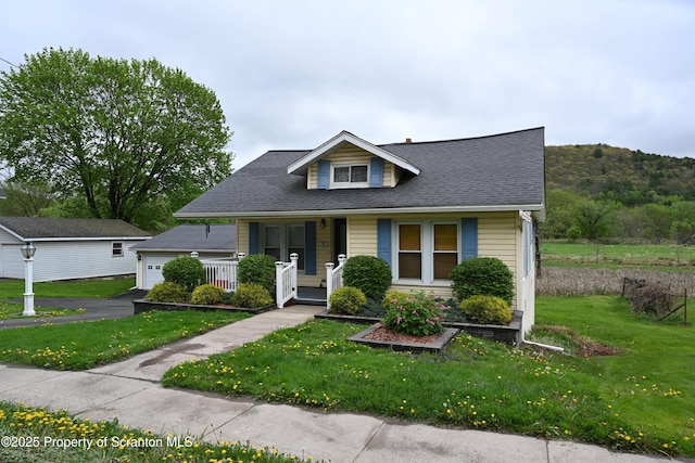 492 Main St, Hallstead, PA 18822 - bungalow-style home with covered porch, aphalt driveway, a garage, a front lawn, and a shingled roof