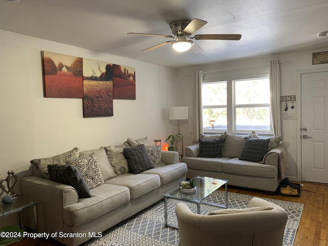 living room with hardwood / wood-style flooring and ceiling fan