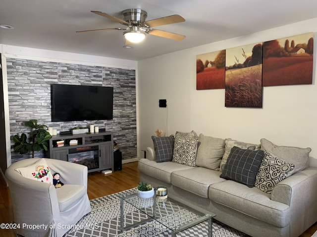 living room featuring wood-type flooring and ceiling fan