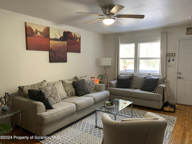 living room featuring ceiling fan and hardwood / wood-style floors