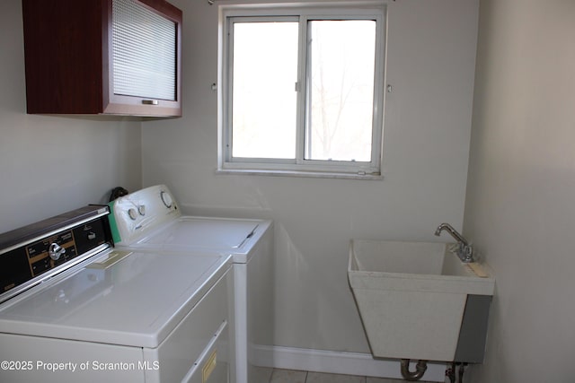 washroom with separate washer and dryer, cabinets, sink, and light tile patterned floors