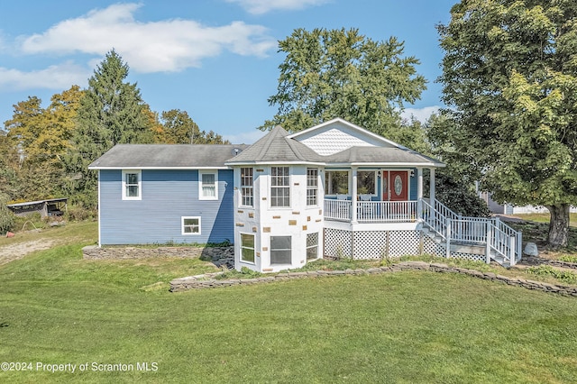 view of front of home featuring covered porch and a front yard