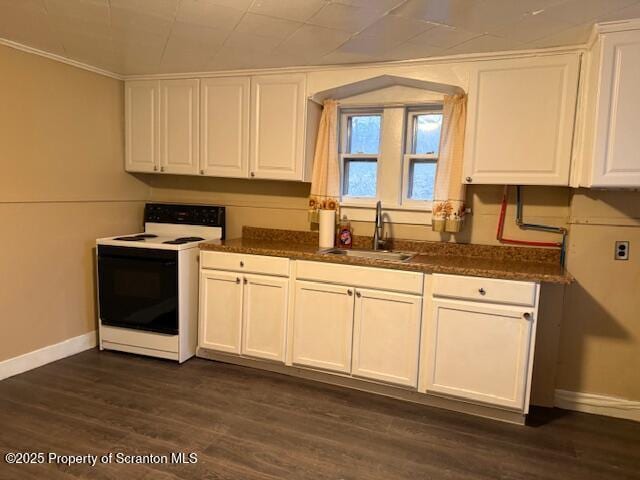 kitchen featuring electric range, dark wood-style flooring, a sink, baseboards, and white cabinets