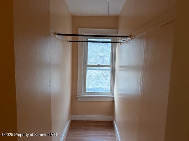 interior space featuring wood finished floors and baseboards