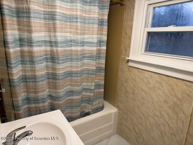 full bathroom with shower / tub combo and a sink