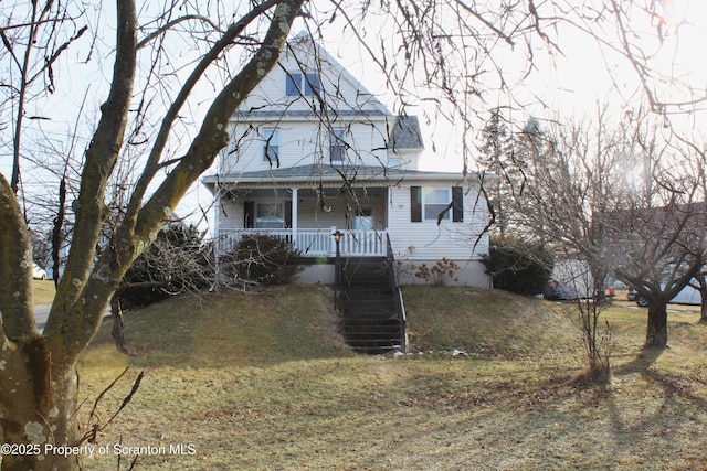 view of front of property with covered porch and a front yard