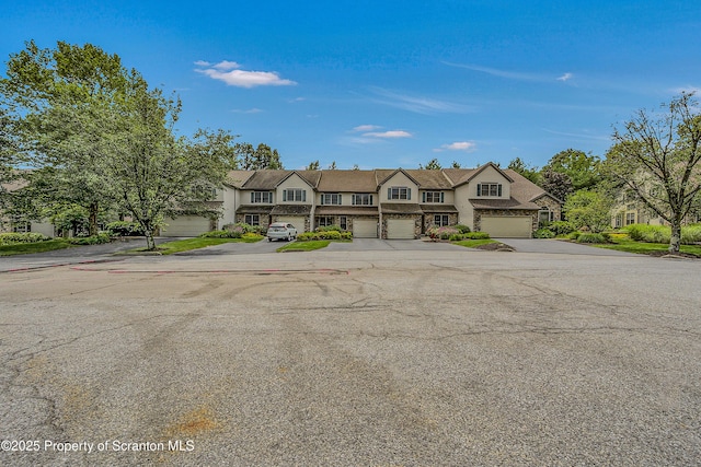 33 Hedge Row Run, Clarks Summit, PA 18411 - traditional-style house featuring concrete driveway, stone siding, a garage, and a residential view