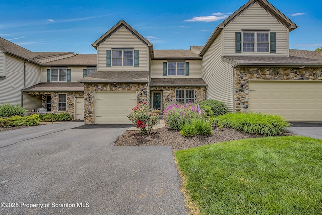 33 Hedge Row Run, Clarks Summit, PA 18411 - view of front of property featuring an attached garage, asphalt driveway, stone siding, and roof with shingles