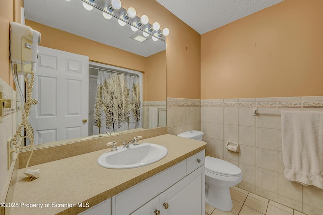 33 Hedge Row Run, Clarks Summit, PA 18411 - bathroom with tile patterned flooring, vanity, wainscoting, tile walls, and a textured ceiling
