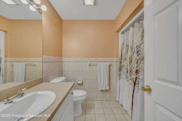 33 Hedge Row Run, Clarks Summit, PA 18411 - bathroom featuring tile patterned floors, tile walls, a wainscoted wall, vanity, and a textured ceiling