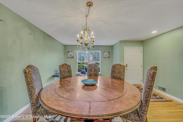 33 Hedge Row Run, Clarks Summit, PA 18411 - dining space featuring light wood-style floors, a textured ceiling, and a chandelier